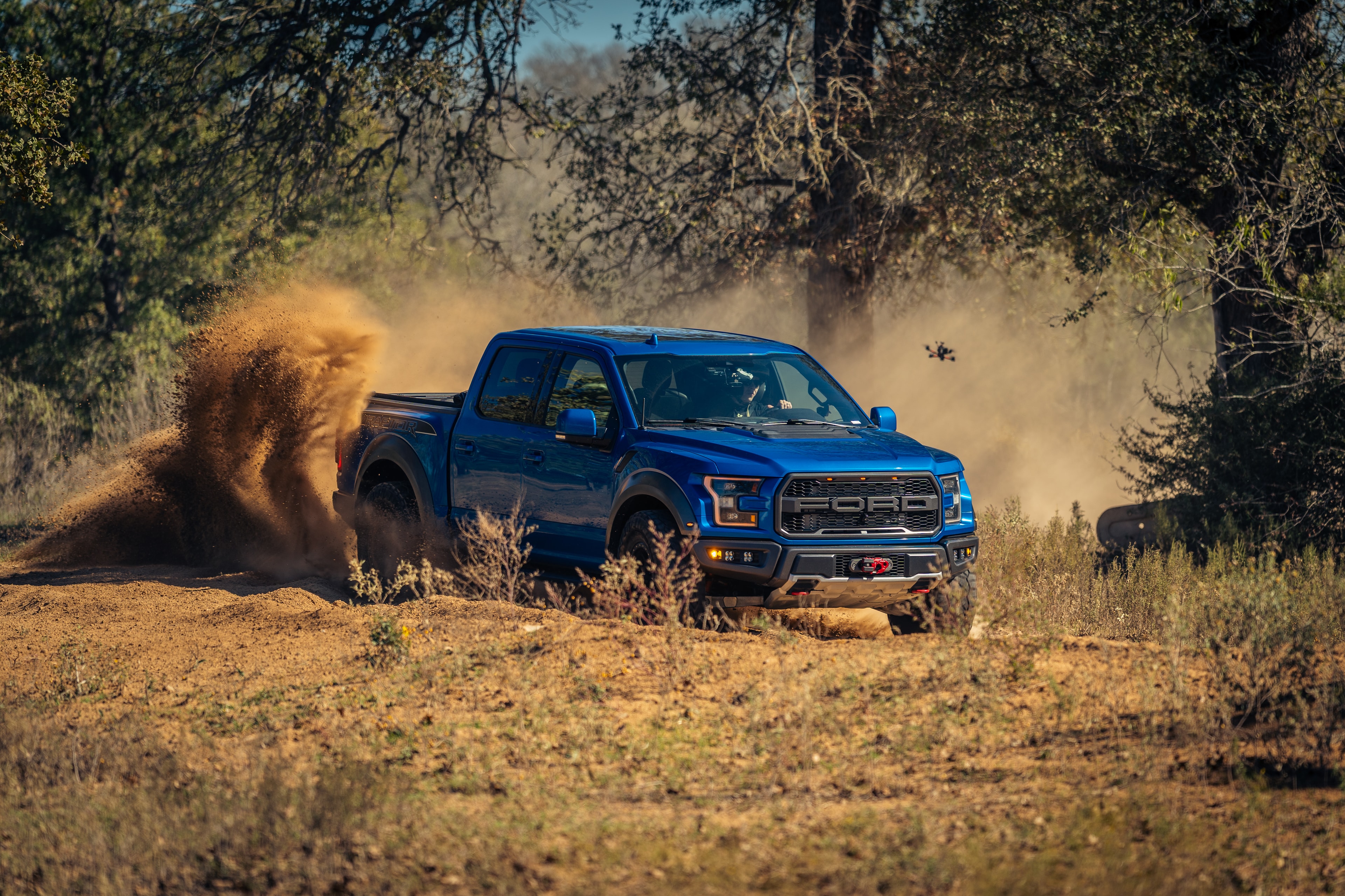 Ford Raptor on two wheels in open field